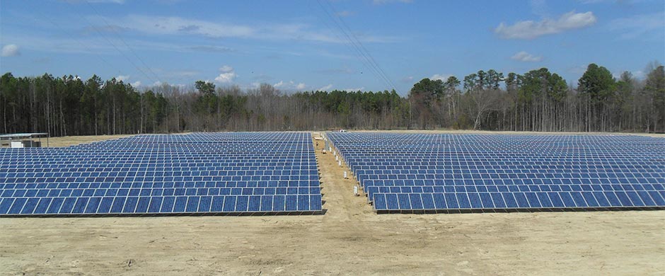 North Carolina solar installation photo showing aisle between two separate solar fields of approximately 1.2 Mega Watts of solar panels.